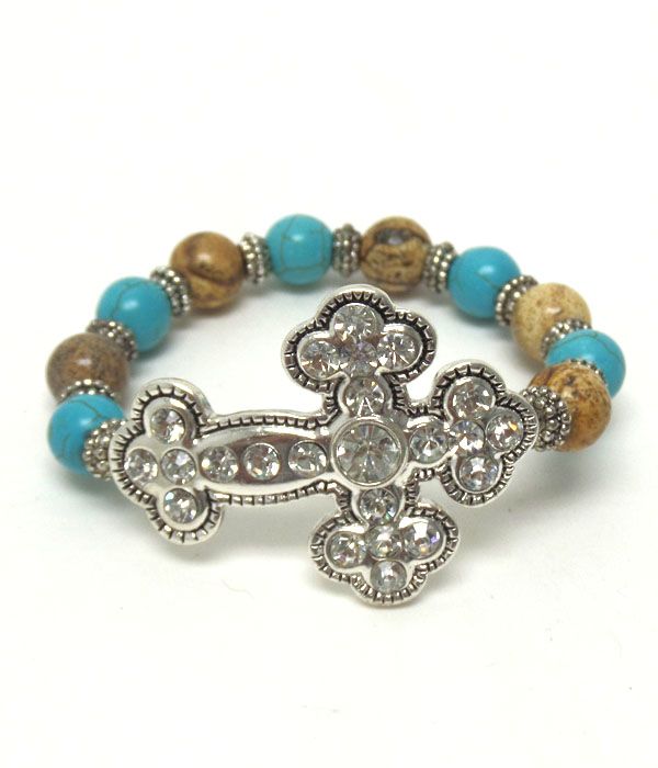 TEXTURED METAL CROSS WITH CRYSTAL ON TURQUOISE AND BROWN STONE STRETCH BRACELET