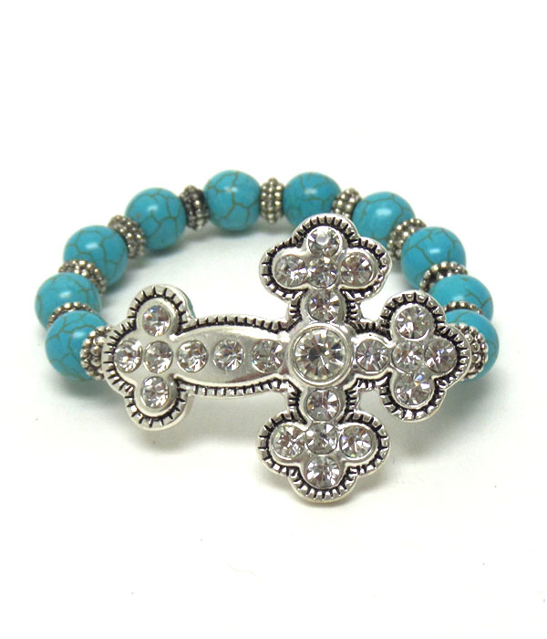 TEXTURED METAL CROSS WITH CRYSTALS ON TURQUOISE STONE STRETCH BRACELET