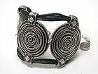 SPIRAL TEXTURED METAL DISK AND LEATHER CORD LINK BRACELET