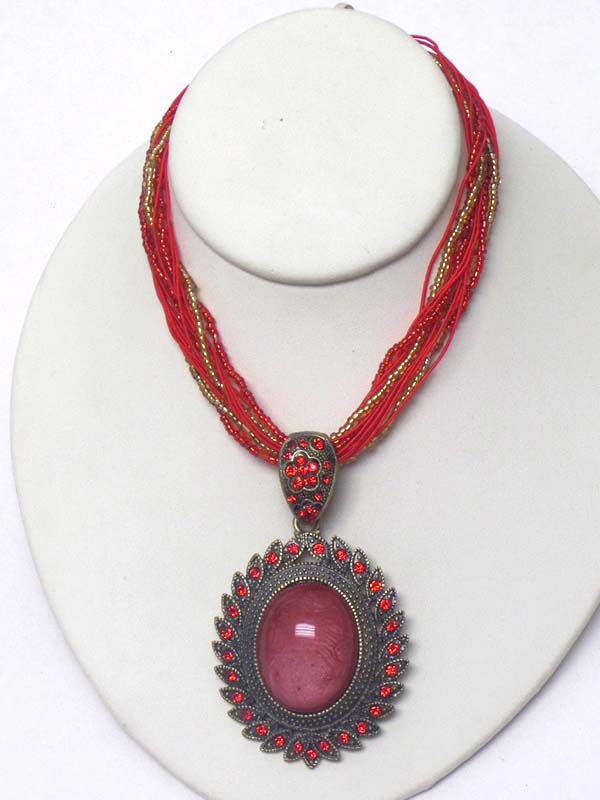 Puffy oval stone and crystal edge pendant and multi seed bead chain mix necklace