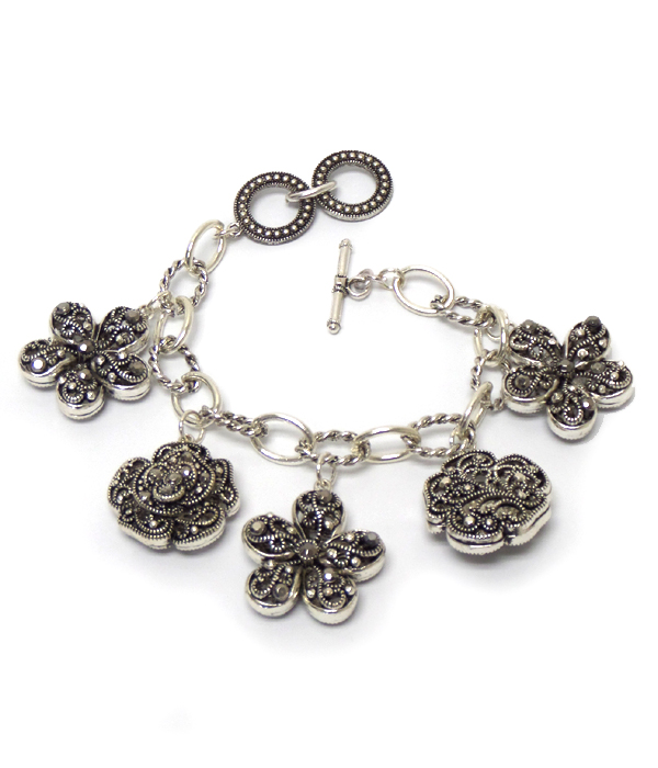 Multi textured metal flower charm toggle bracelet 