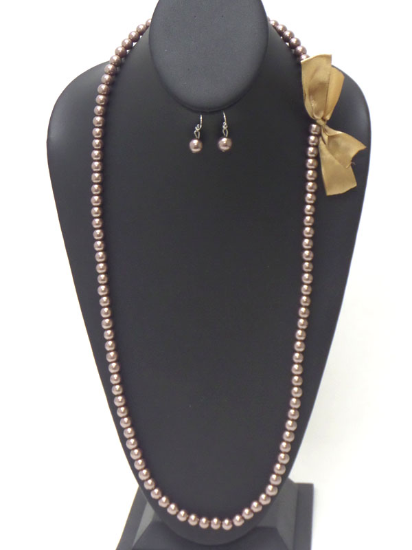 Bow side accent long pearl necklace earring set