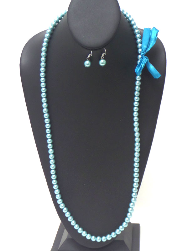 Bow side accent long pearl necklace earring set