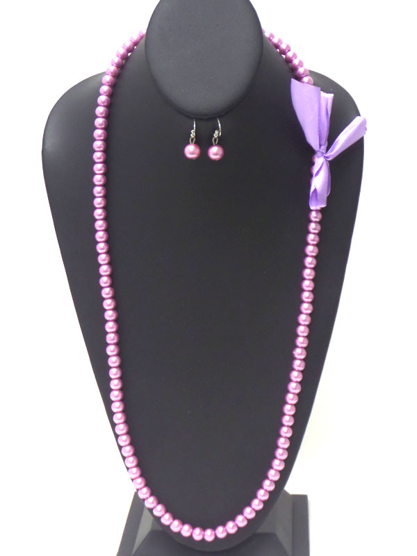 Bow side accent long pearl necklace earring set