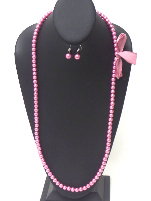 Bow side accent long pearl necklace earring set