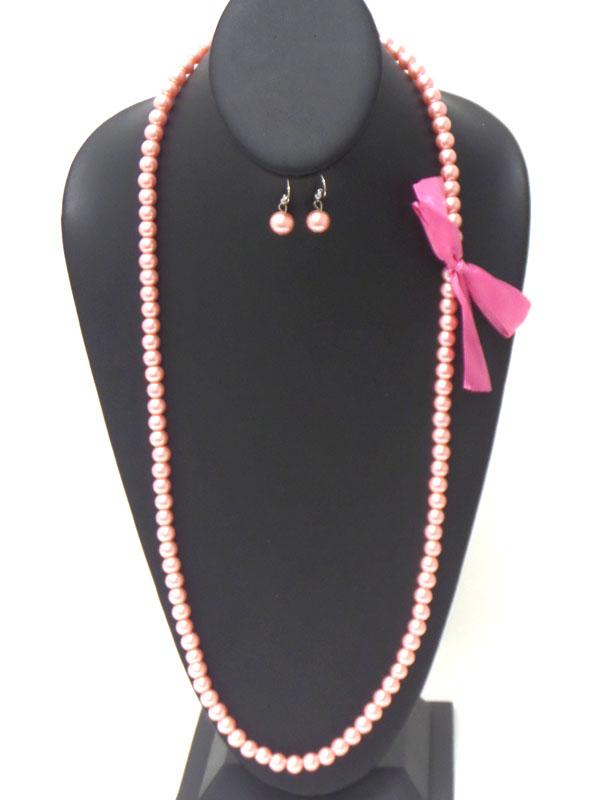 Bow side accent long pearl necklace earring set