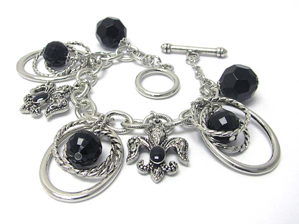 Textured metal fleur de lis and hoop charm dangle bracelet