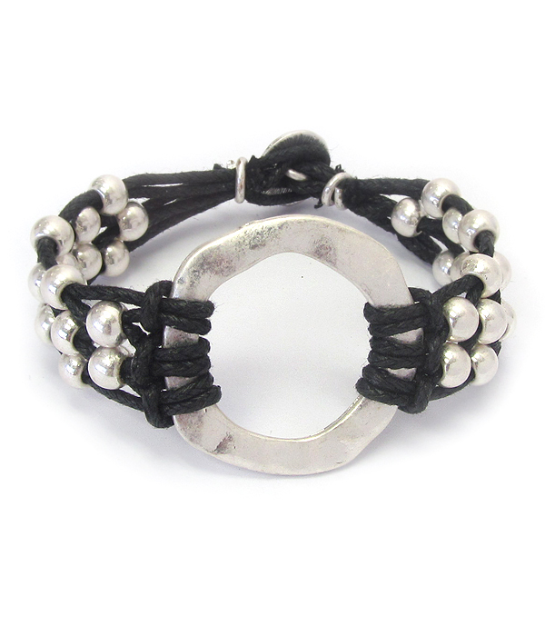 Hammered metal hoop and wax cord toggle bracelet