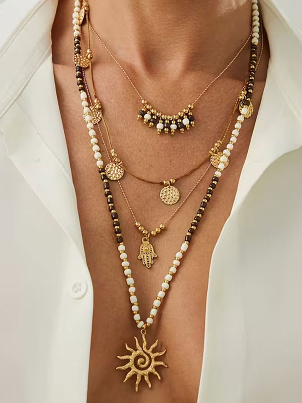 Boho style multi layer sunburst and hamsa necklace